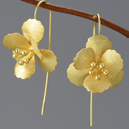pair of gold six petal flower drop earrings